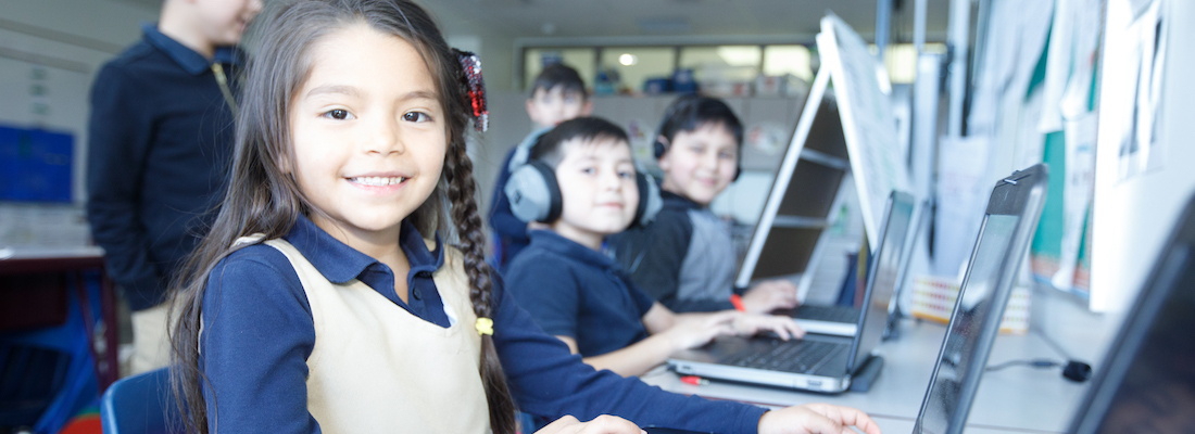 Student posing using a laptop